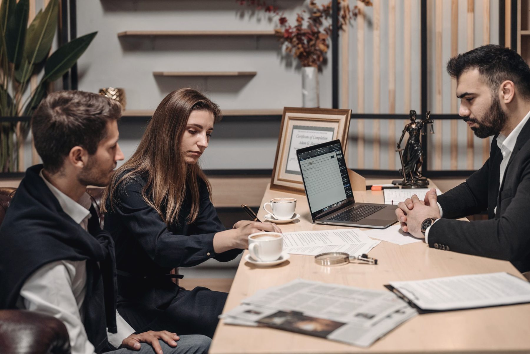 Colleagues reviewing documents together around a boardroom table