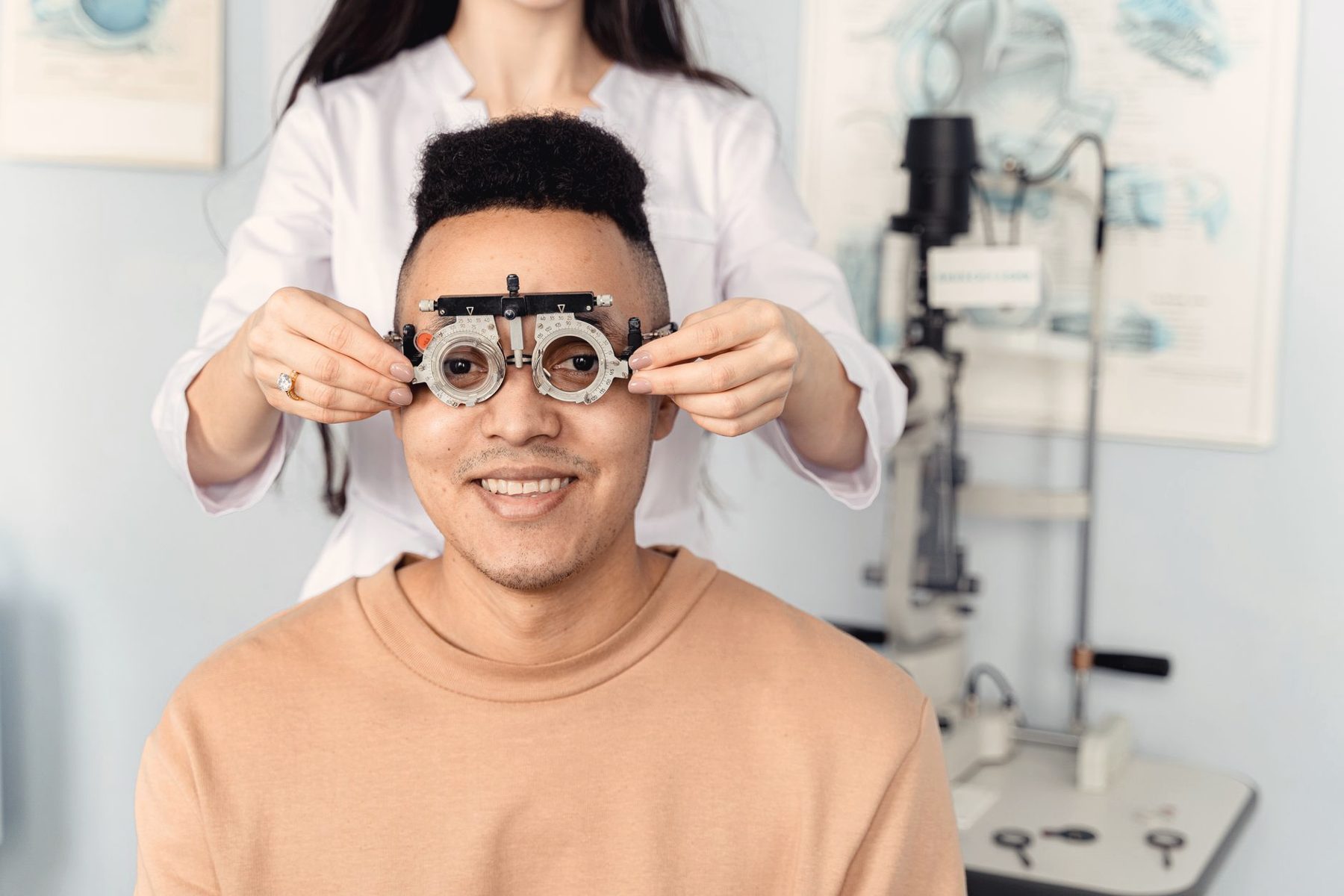 A smiling man being fitted for new lenses at an eye care clinic